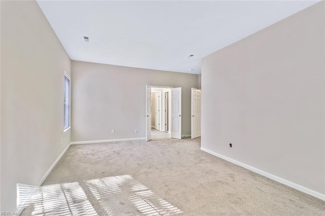 unfurnished room with light colored carpet