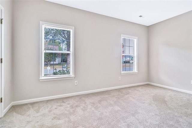 carpeted spare room with plenty of natural light