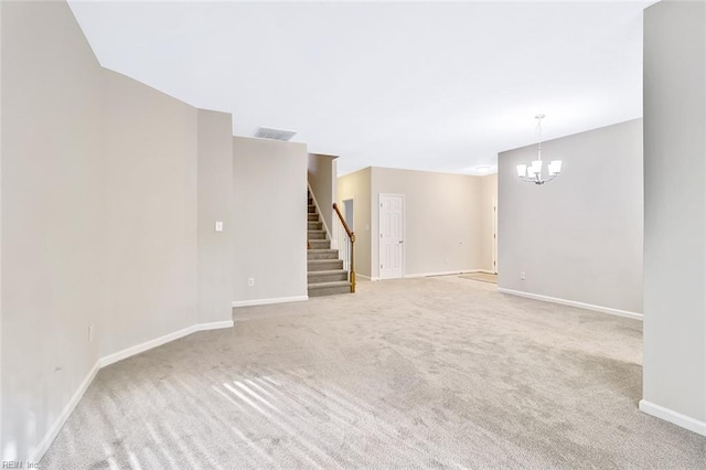 basement with light colored carpet and a notable chandelier