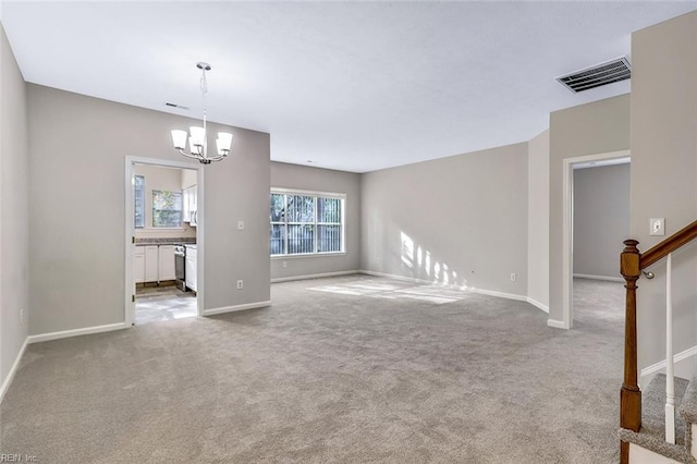 unfurnished living room with light carpet and a chandelier