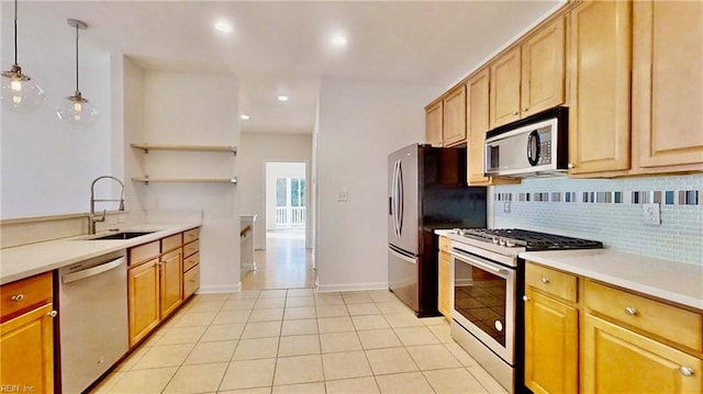 kitchen featuring tasteful backsplash, stainless steel appliances, sink, pendant lighting, and light tile patterned floors