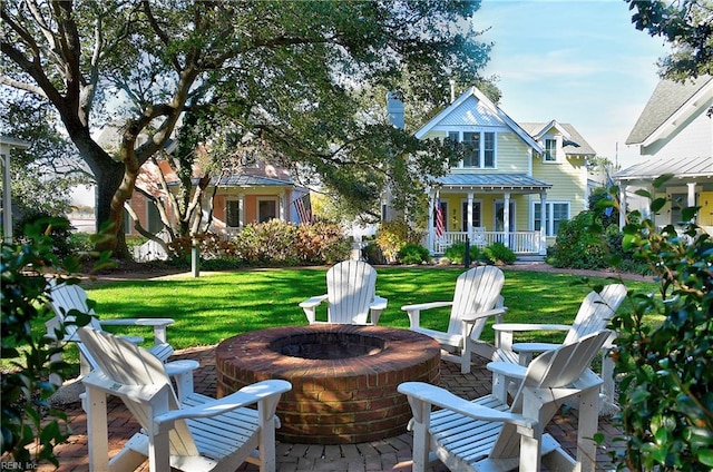 view of patio / terrace featuring covered porch and an outdoor fire pit