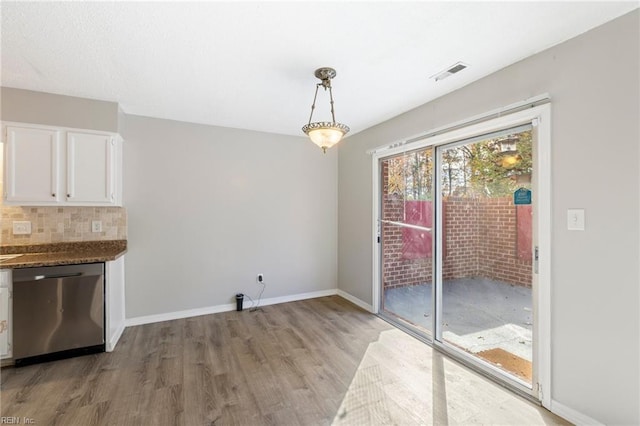 unfurnished dining area with light hardwood / wood-style flooring