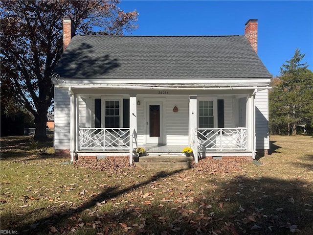 view of front of home featuring covered porch and a front yard