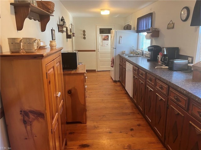 kitchen featuring dishwasher, light hardwood / wood-style flooring, and sink