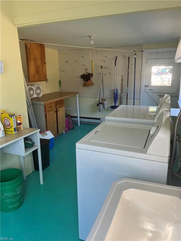 washroom featuring a baseboard heating unit and washing machine and clothes dryer