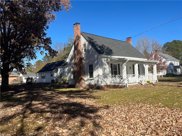 view of home's exterior with a lawn and covered porch