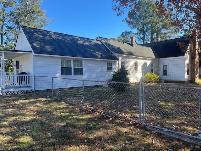 view of side of home featuring a yard and a wooden deck