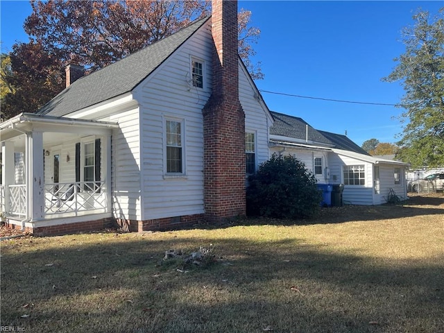 view of home's exterior featuring a lawn and covered porch