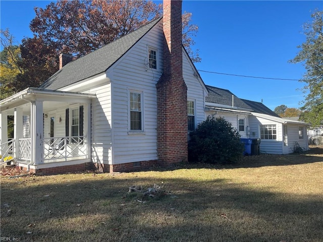 view of side of property with a lawn and a porch