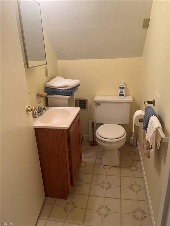 bathroom featuring tile patterned floors, vanity, and toilet