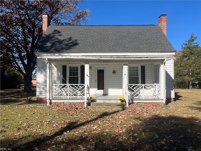 view of front of home with covered porch and a front yard