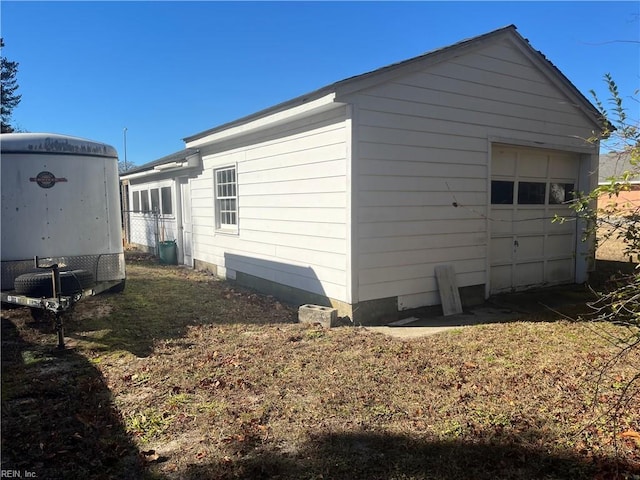 view of home's exterior featuring an outdoor structure and a garage