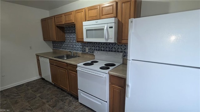 kitchen featuring white appliances, sink, and tasteful backsplash