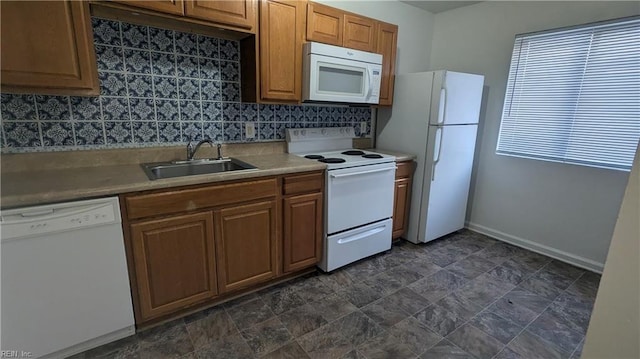 kitchen featuring tasteful backsplash, sink, and white appliances