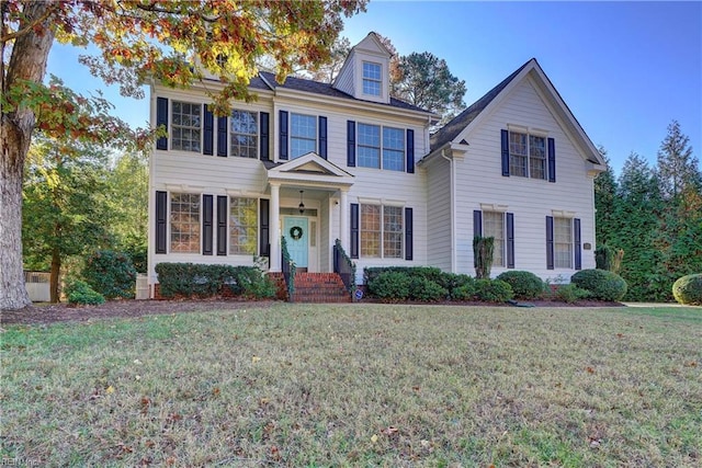 colonial home with a front lawn