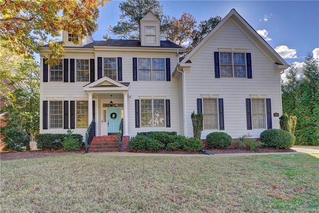 colonial-style house with a front lawn