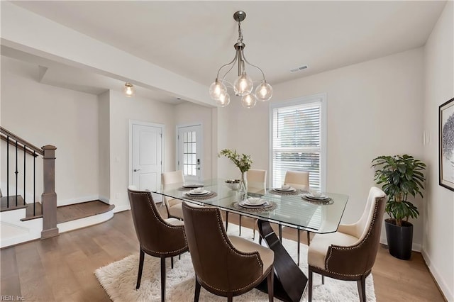 dining space featuring a chandelier and hardwood / wood-style flooring