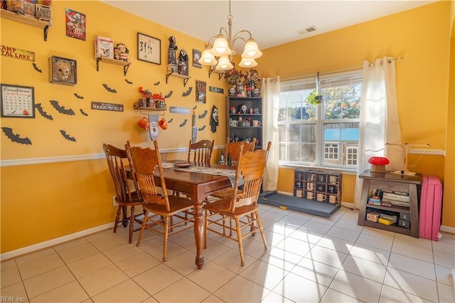 tiled dining room with a chandelier