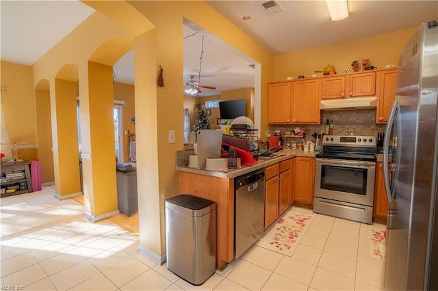 kitchen with appliances with stainless steel finishes, backsplash, light tile patterned floors, and ceiling fan