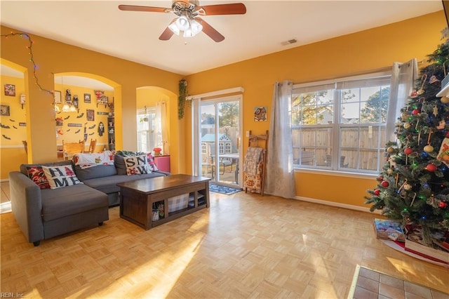 living room with light parquet flooring and ceiling fan