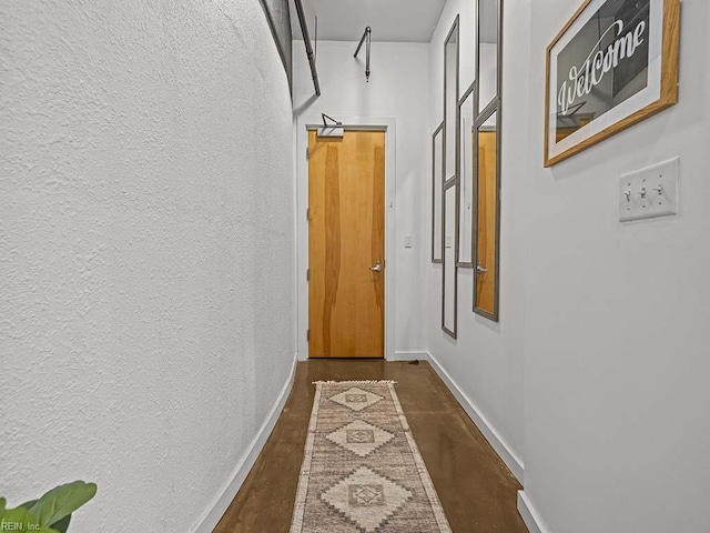 corridor featuring dark wood-type flooring