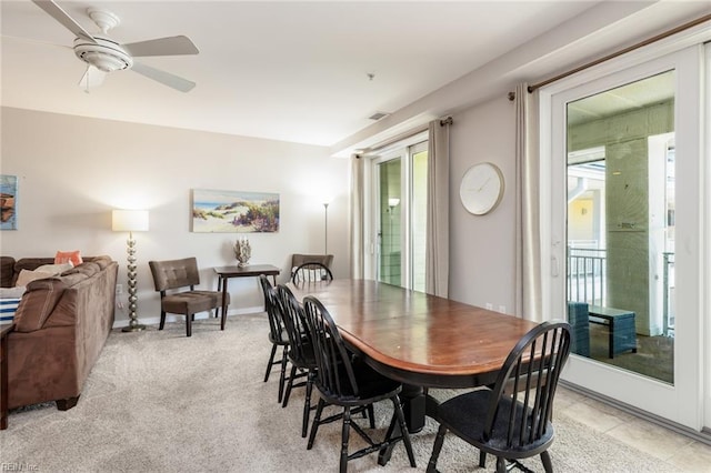 dining room featuring light carpet and ceiling fan