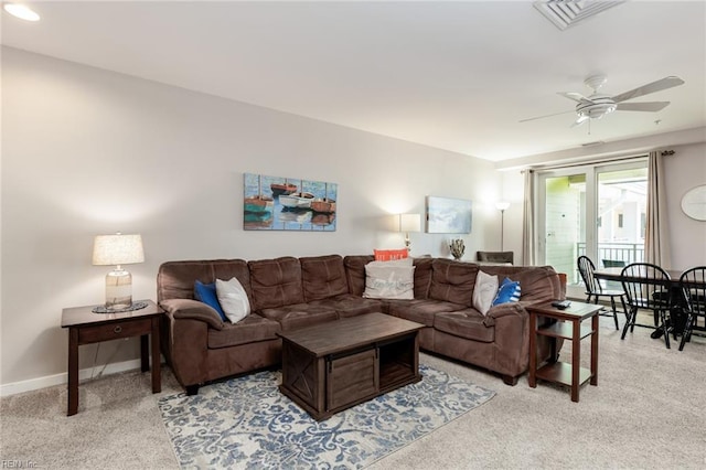 carpeted living room featuring ceiling fan