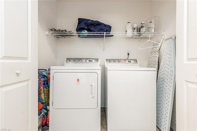 clothes washing area with independent washer and dryer