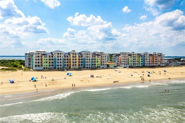 drone / aerial view featuring a beach view and a water view