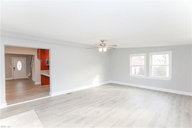 unfurnished room featuring ceiling fan and light hardwood / wood-style flooring