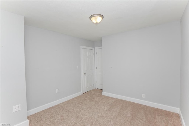 spare room with light colored carpet