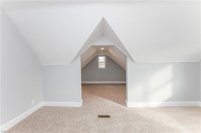 bonus room featuring light carpet and lofted ceiling