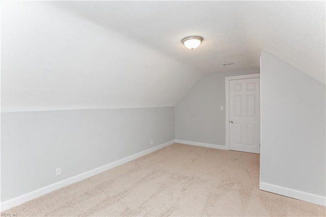 bonus room with light carpet and lofted ceiling