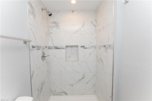 bathroom with a tile shower