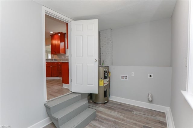 laundry room featuring hookup for an electric dryer, hookup for a washing machine, light wood-type flooring, electric water heater, and sink