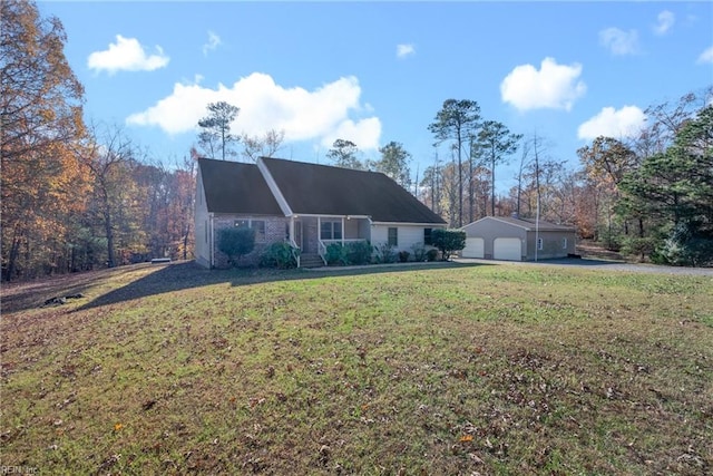 view of front of house with an outbuilding, a front lawn, and a garage