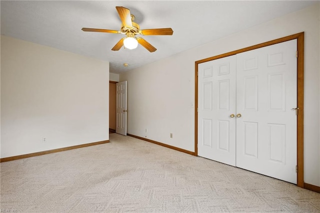 unfurnished bedroom featuring ceiling fan, light carpet, and a closet