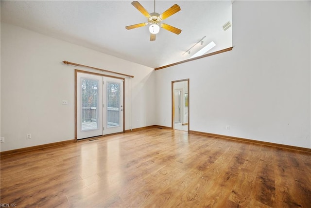 empty room with ceiling fan and light hardwood / wood-style flooring