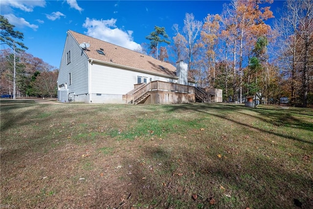 back of property with a lawn and a wooden deck