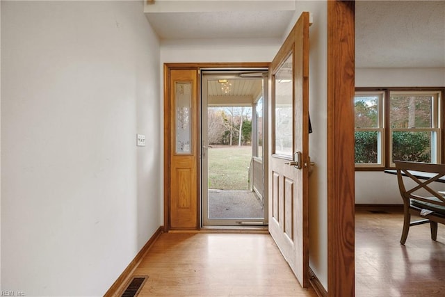 doorway with light wood-type flooring