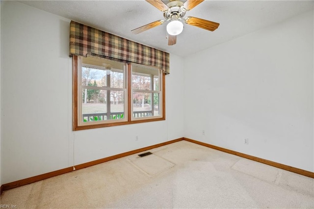 unfurnished room featuring ceiling fan and carpet floors