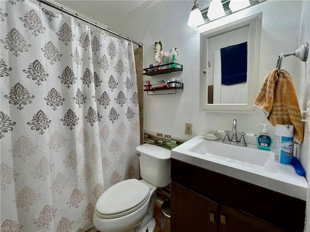 bathroom with curtained shower, vanity, and toilet