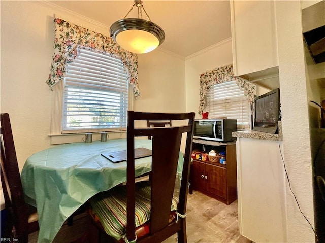 dining space with crown molding