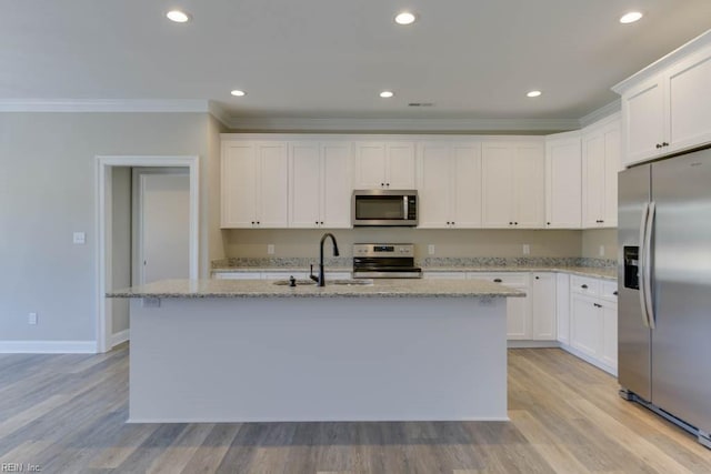 kitchen with white cabinetry, sink, a center island with sink, and appliances with stainless steel finishes