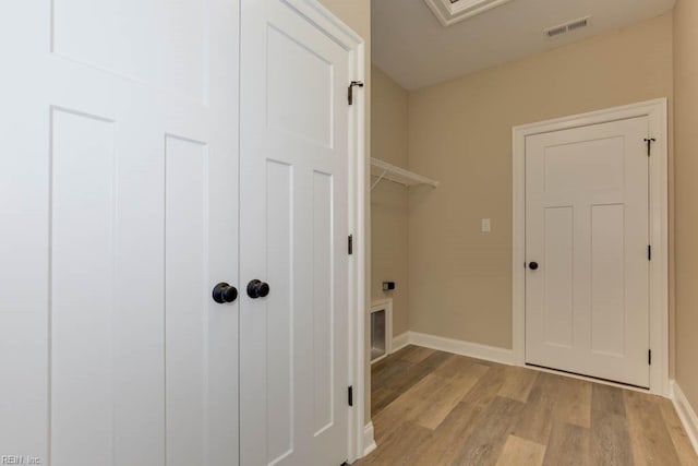 laundry room with light hardwood / wood-style flooring