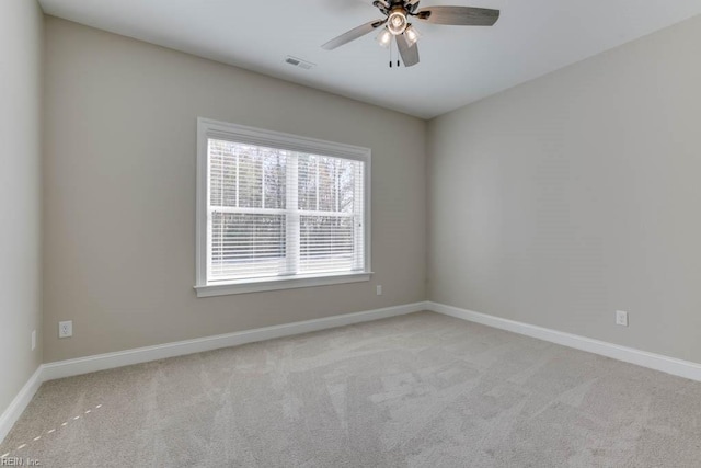 carpeted spare room featuring ceiling fan