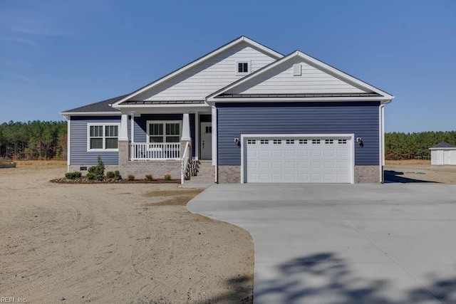 craftsman inspired home featuring a garage and covered porch