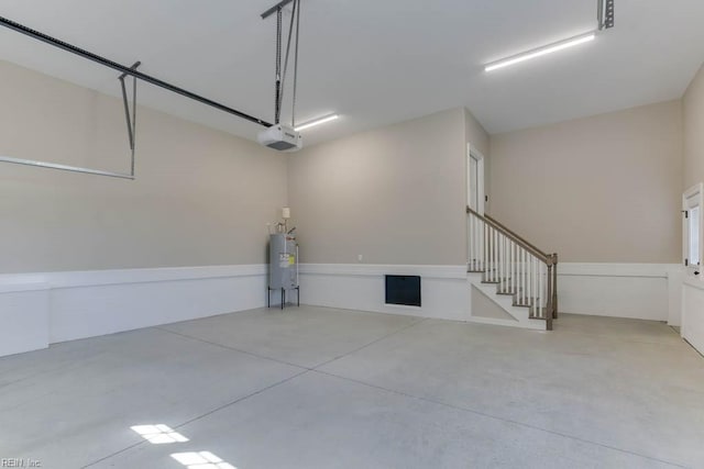 garage featuring a garage door opener and water heater