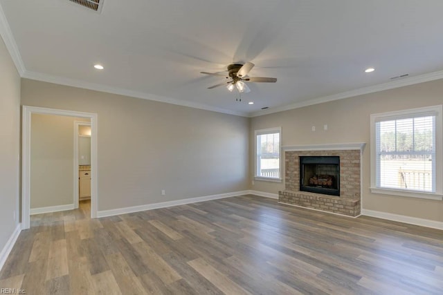 unfurnished living room featuring a fireplace, ceiling fan, hardwood / wood-style floors, and crown molding